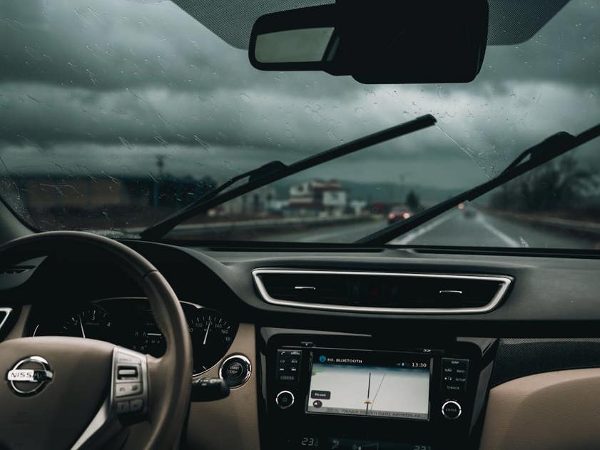 Car windscreen wipers in use in a Nissan car