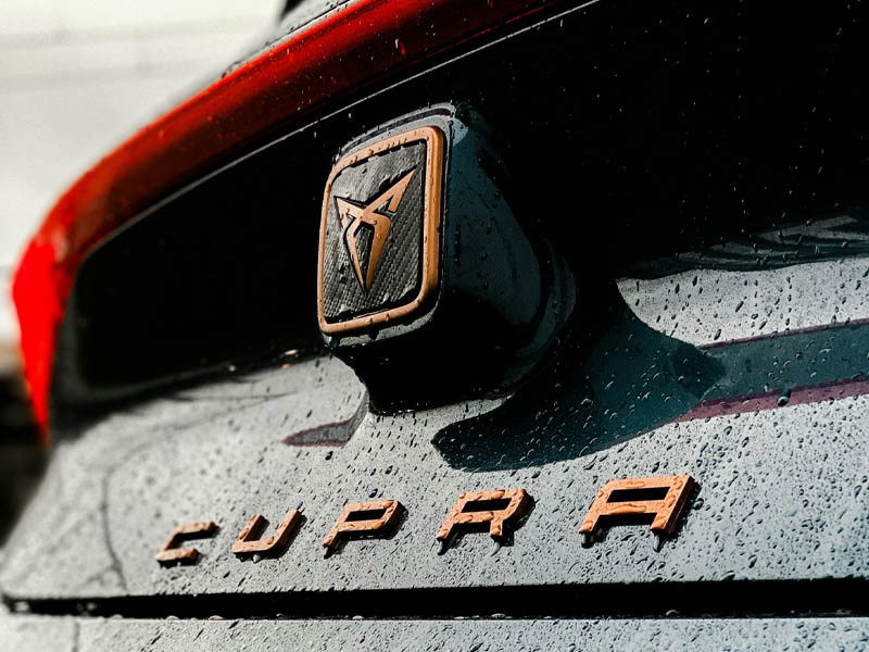 Cupra lease car badge in the rain