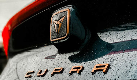 Cupra lease car badge in the rain