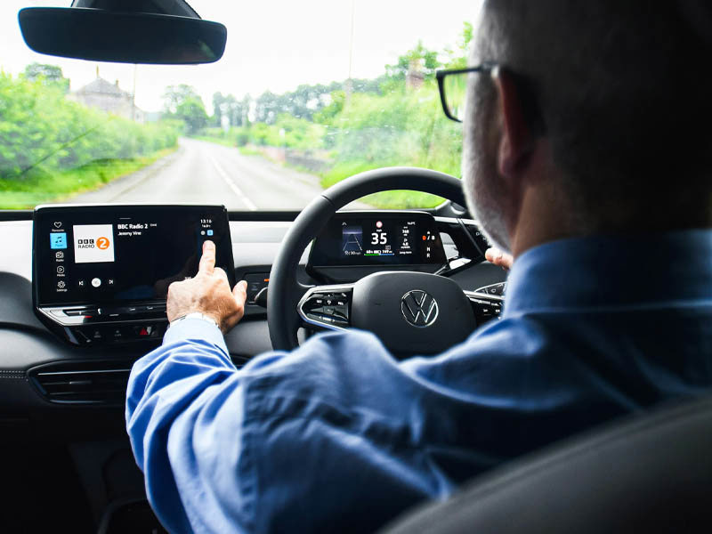 Man using infotainment system in a Volkswagen lease car