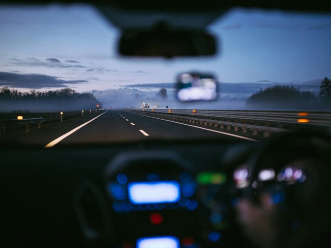 person driving on motorway at night