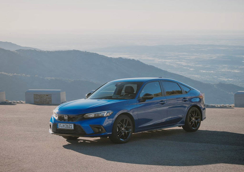 Blue Honda Civic with hills in the background