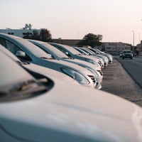 Row of parked cars in a sunlit urban setting