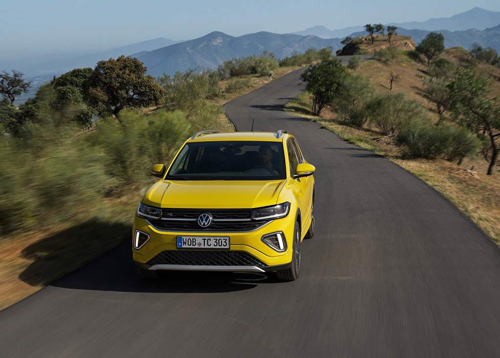 Volkswagen T-Cross lease car in yellow driving on the road