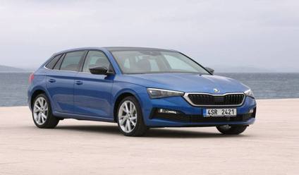 An image of the Skoda Scala, a small family car, parked on a scenic road with a sky in the background.