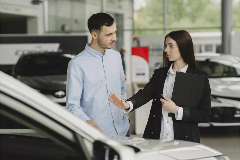 Man and woman looking at a car