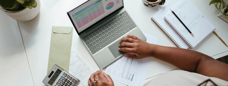 a person sitting at the table with a laptop