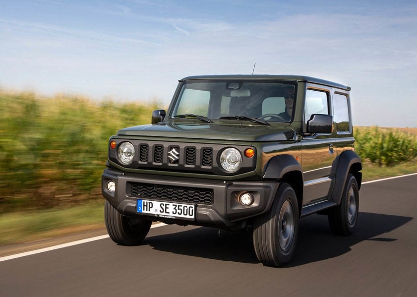 Black Suzuki Jimny driving on the road