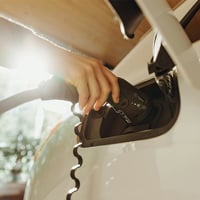 a person charging an electric car