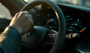 Driver pressing their hand on their car horn