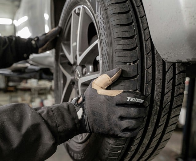 a man working on a tire in a garage
