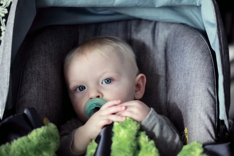 baby in grey carseat