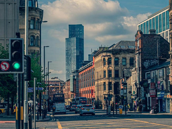 Manchester city centre road with Deansgate tower in the background