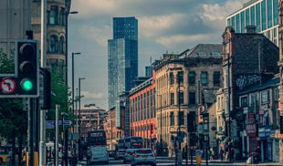 Manchester city centre road with Deansgate tower in the background