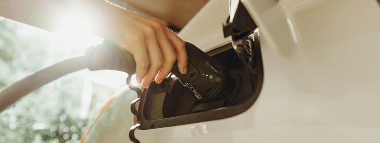 a person pumping gas into a car at a gas station