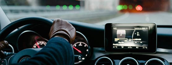 Person driving a premium car with leather driving gloves on