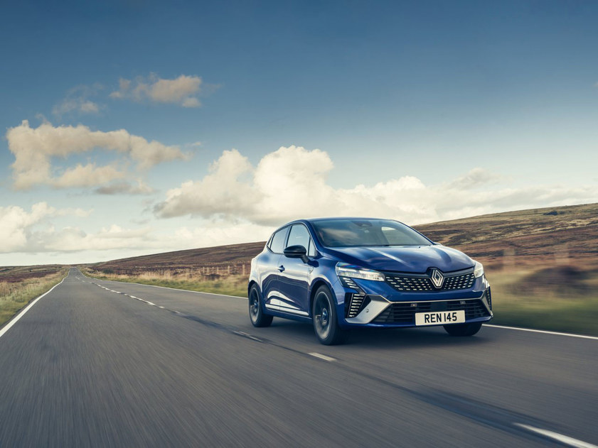 blue renault clio driving on road