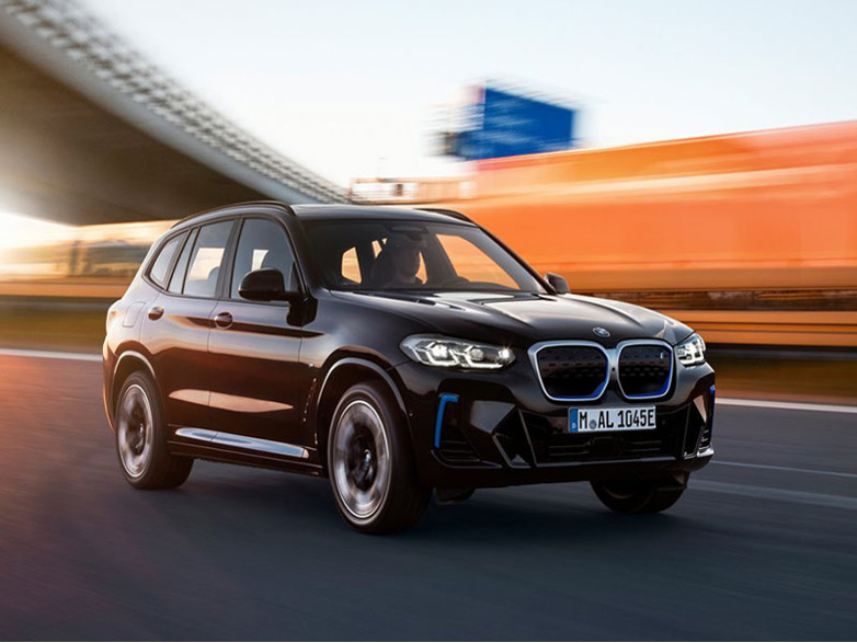 black bmw ix3 driving on the road