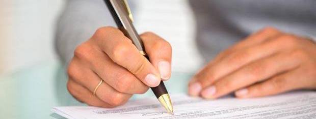 person signing a document