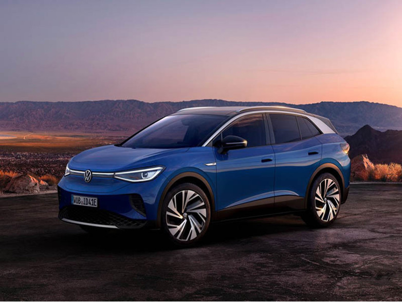 blue volkswagen id4 with mountains in the background