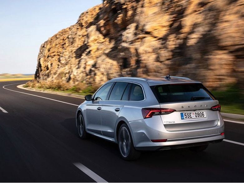 silver skoda octavia estate driving on the road