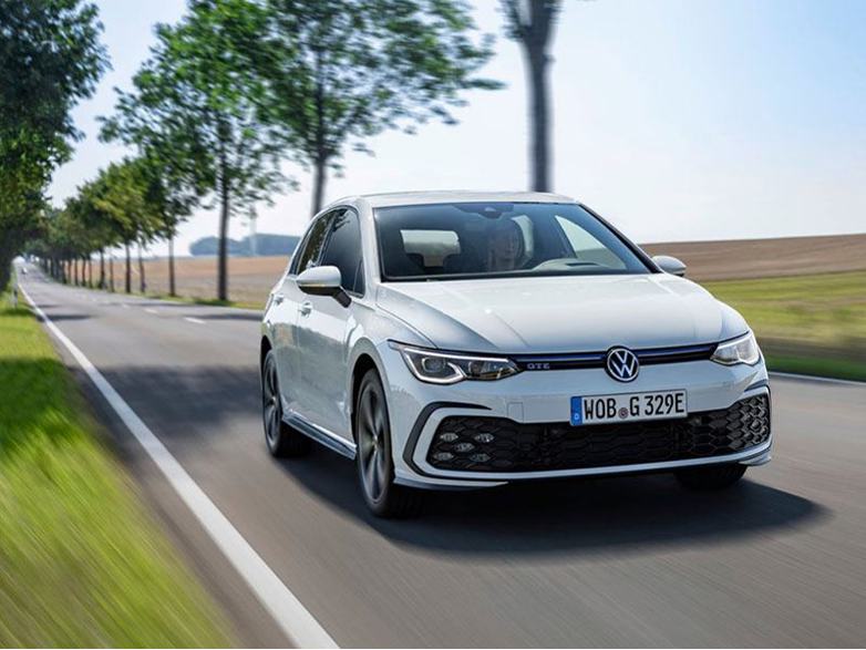 white volkswagen golf driving on road