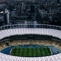 an aerial view of a soccer stadium in a city
