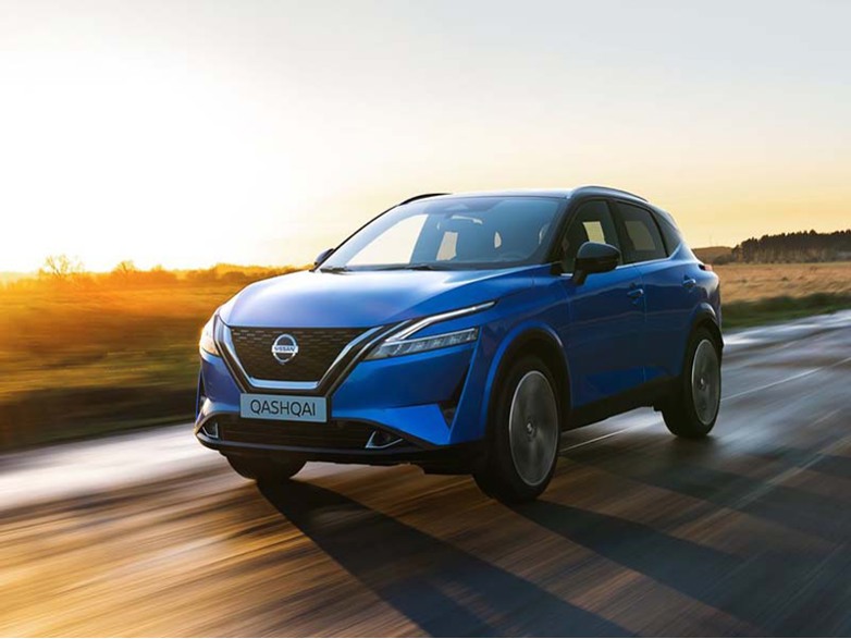 blue nissan qashqai driving on the road