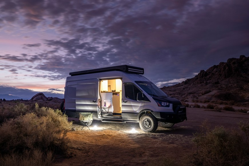 Converted van parked in desert at night