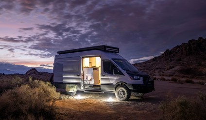 Converted van parked in desert at night